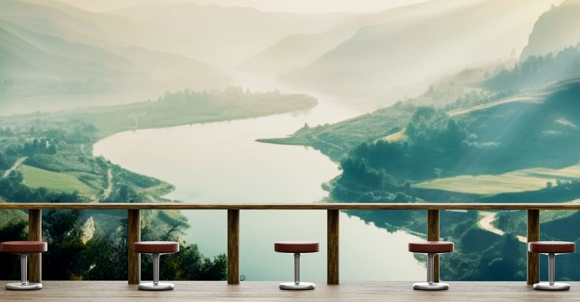 A row of seats along a counter, facing a river valley that opens into the distance